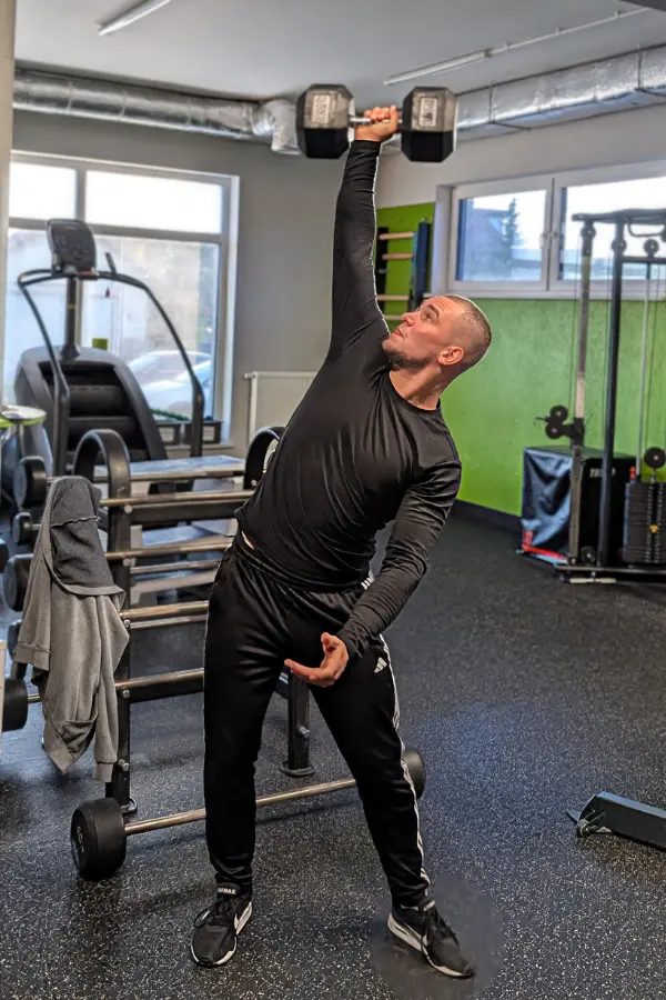 Marcel Gielezy wyciska hantel nad głowę